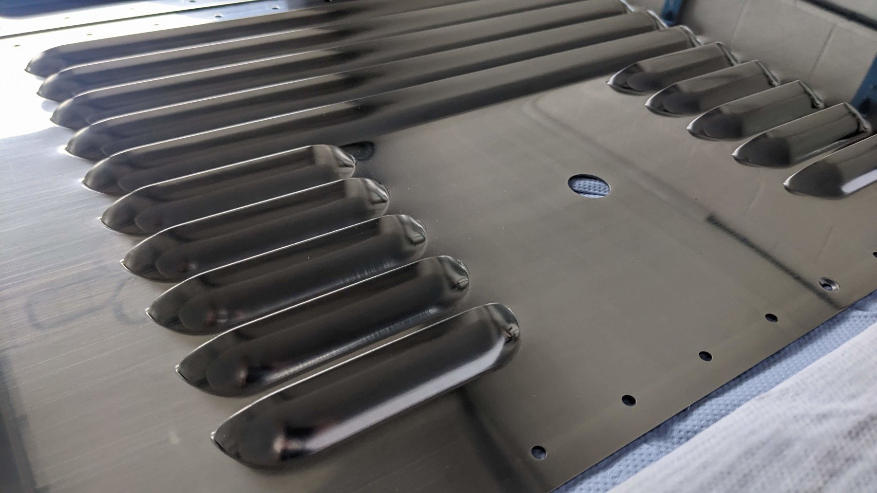 Two louvre sizes in a polished aluminium panel